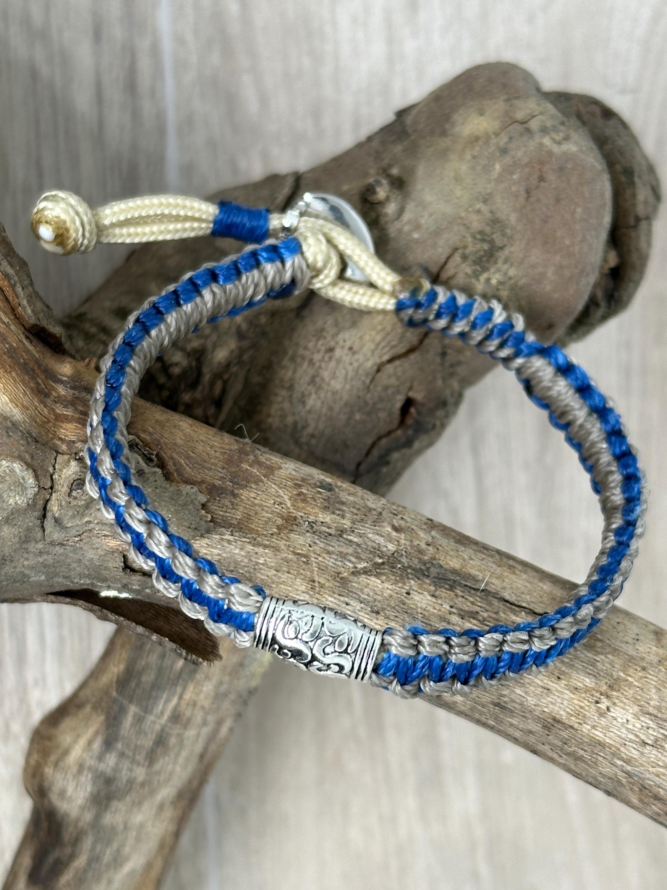 Adjustable Closure Wristlet bracelet with gold charm and button.