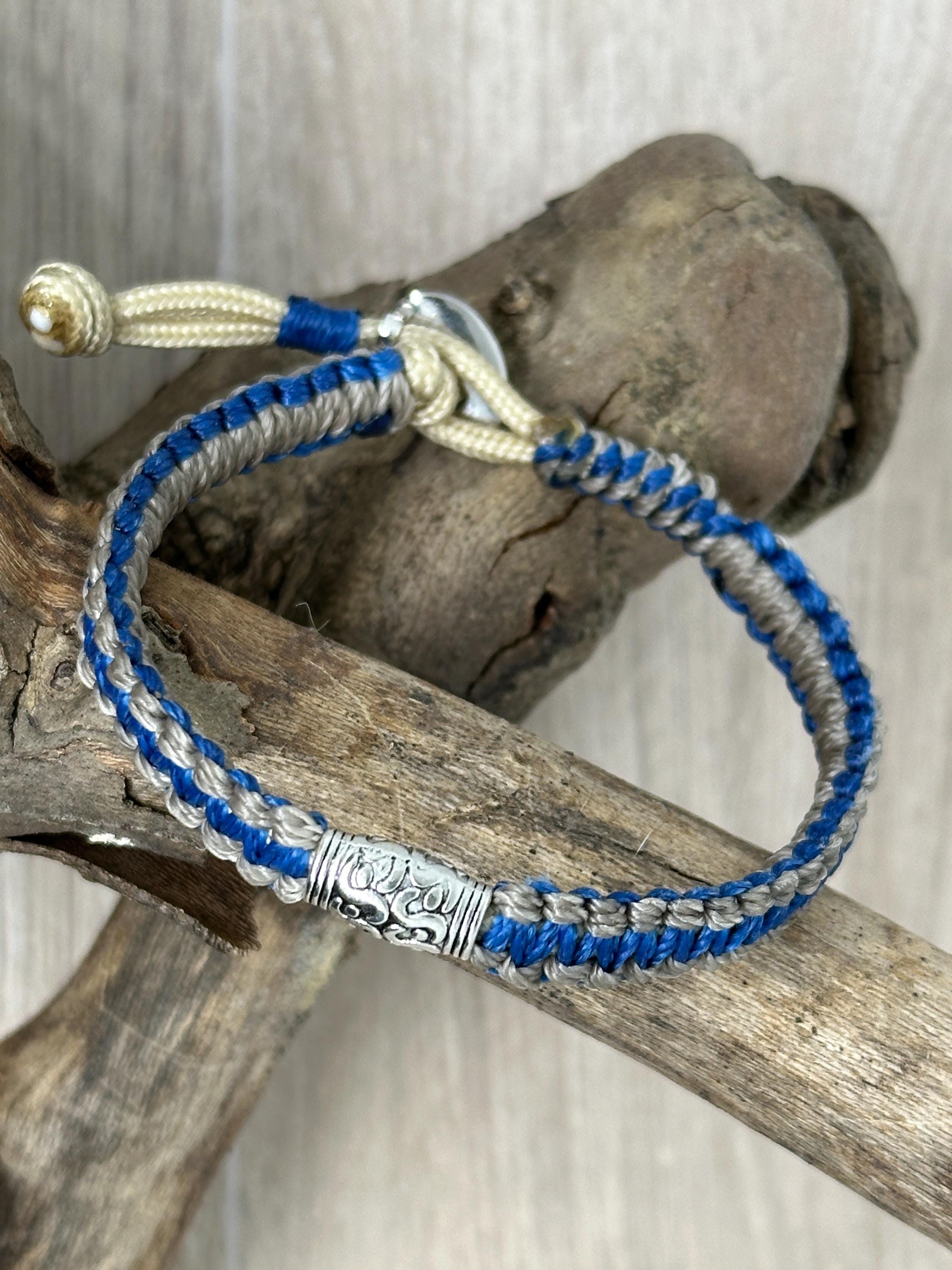 Adjustable Closure Wristlet bracelet with gold charm and button.