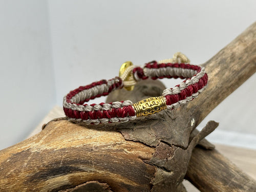 Adjustable Closure Wristlet bracelet with gold charm and button.
