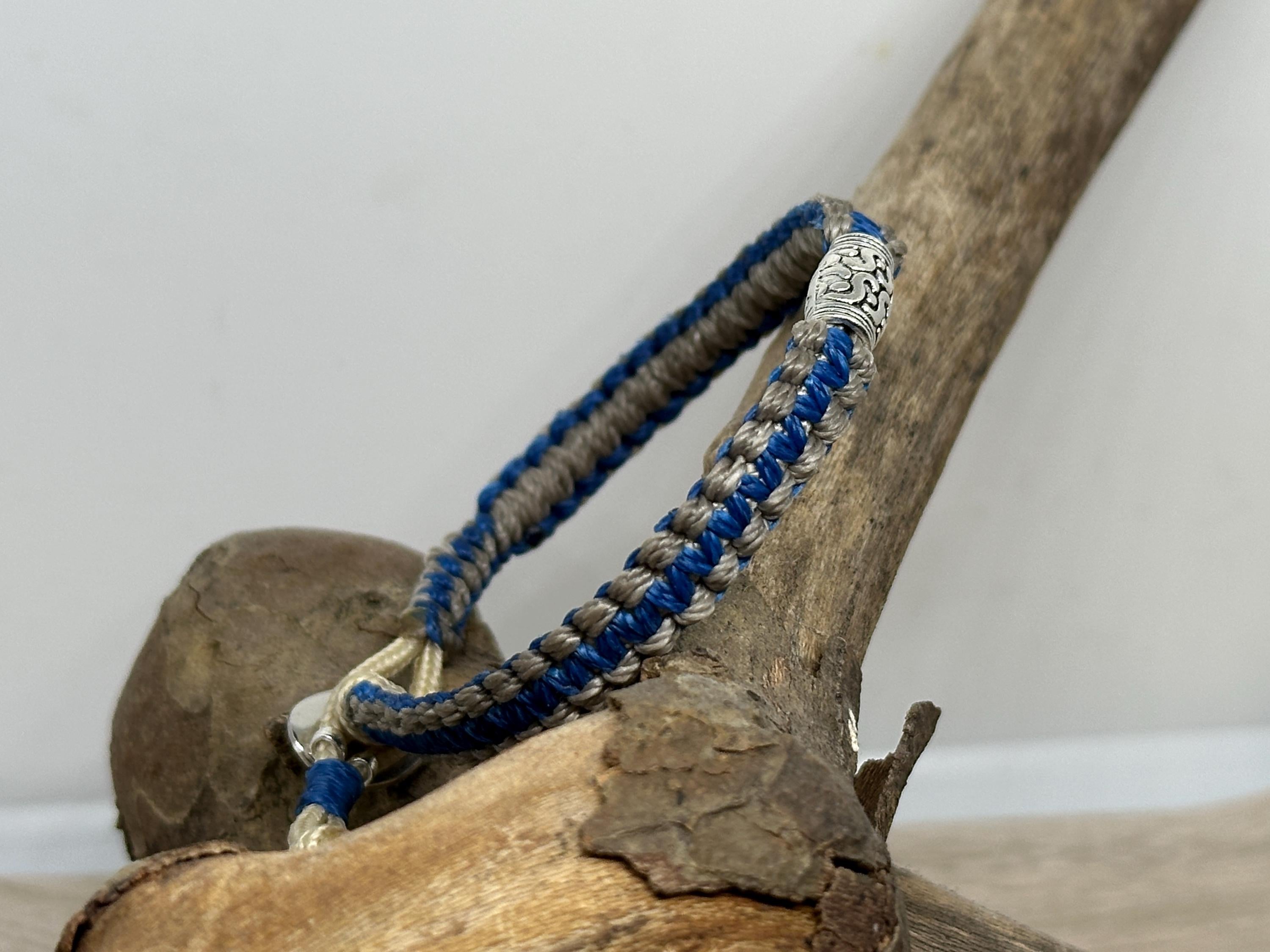 Adjustable Closure Wristlet bracelet with gold charm and button.
