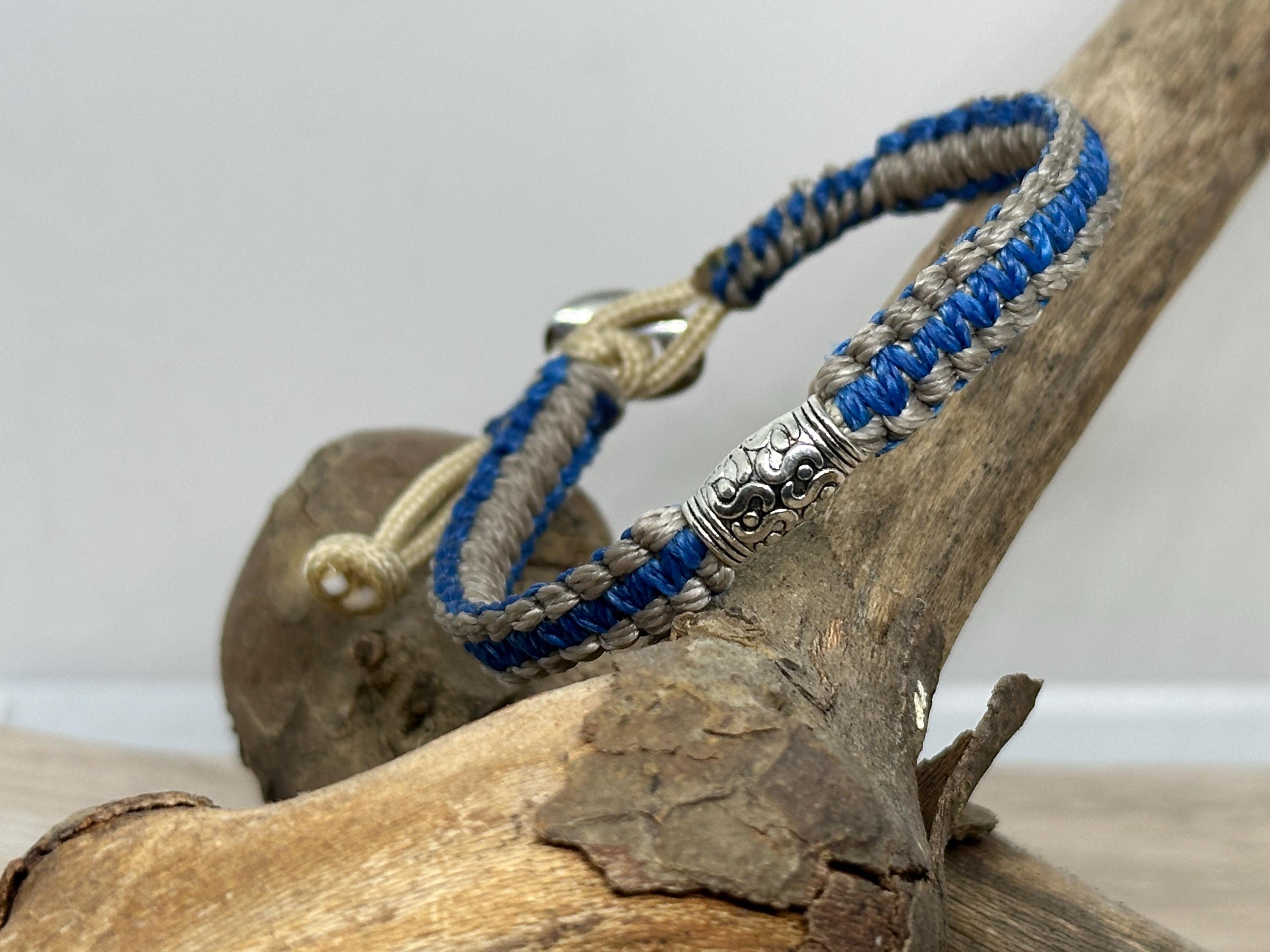 Adjustable Closure Wristlet bracelet with gold charm and button.